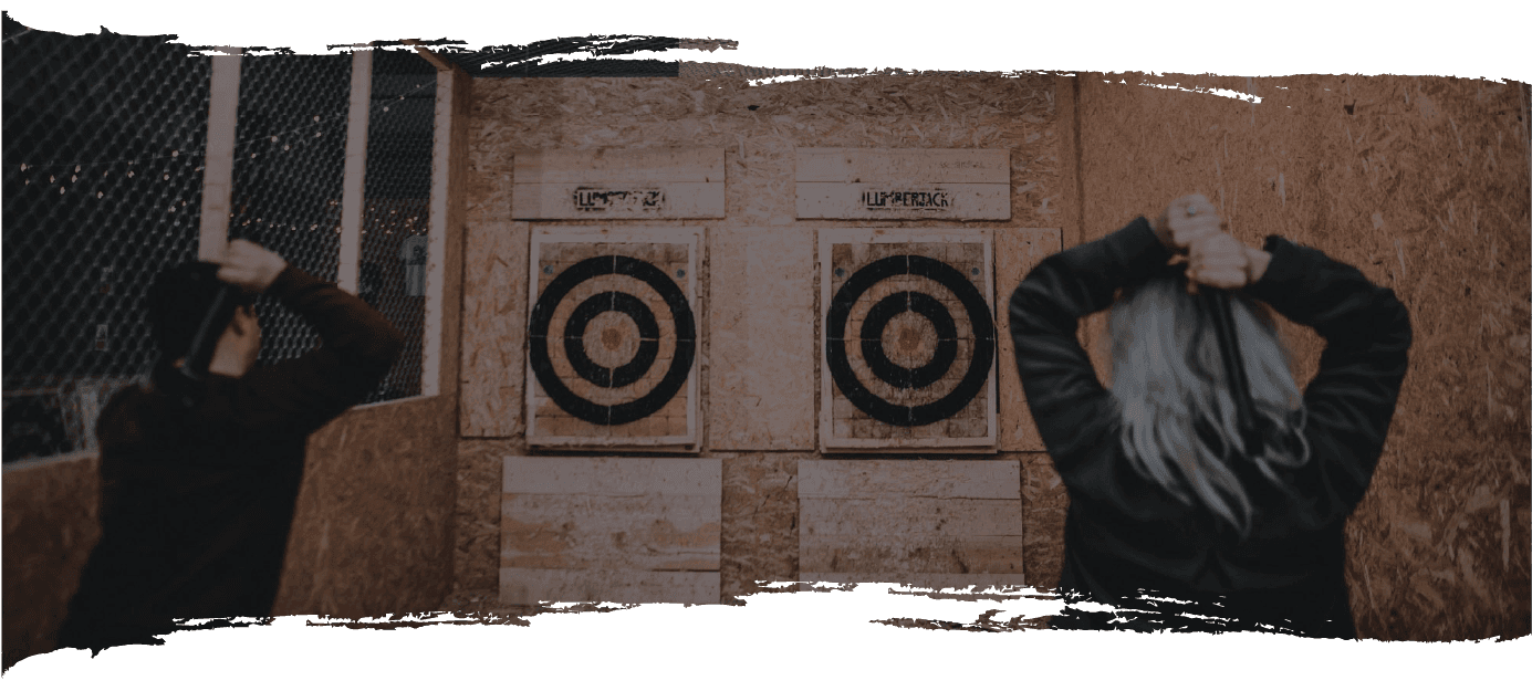 Guests throwing axes towards wooden targets at Lumberjack Axe Throwing Cardiff